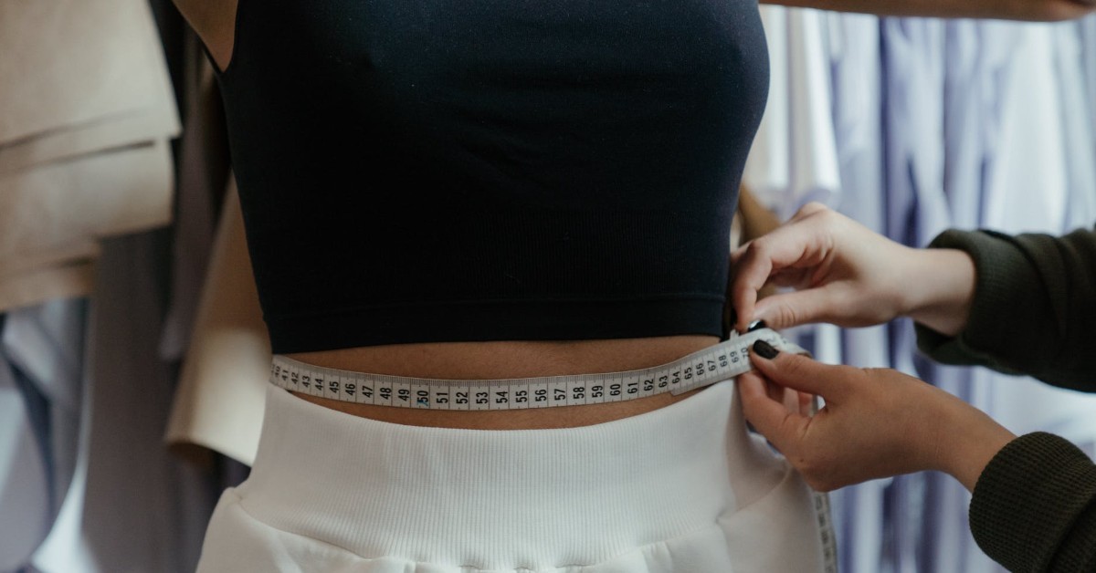 Tailor measuring woman’s waist | Clothing Alterations for your body type