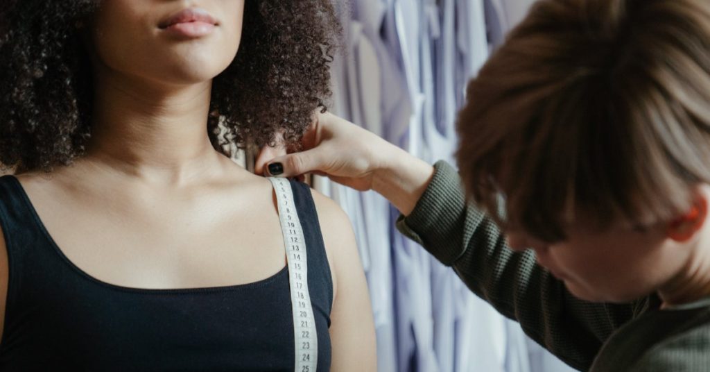 Dressmaker taking woman's measurements | What does a dressmaker do?