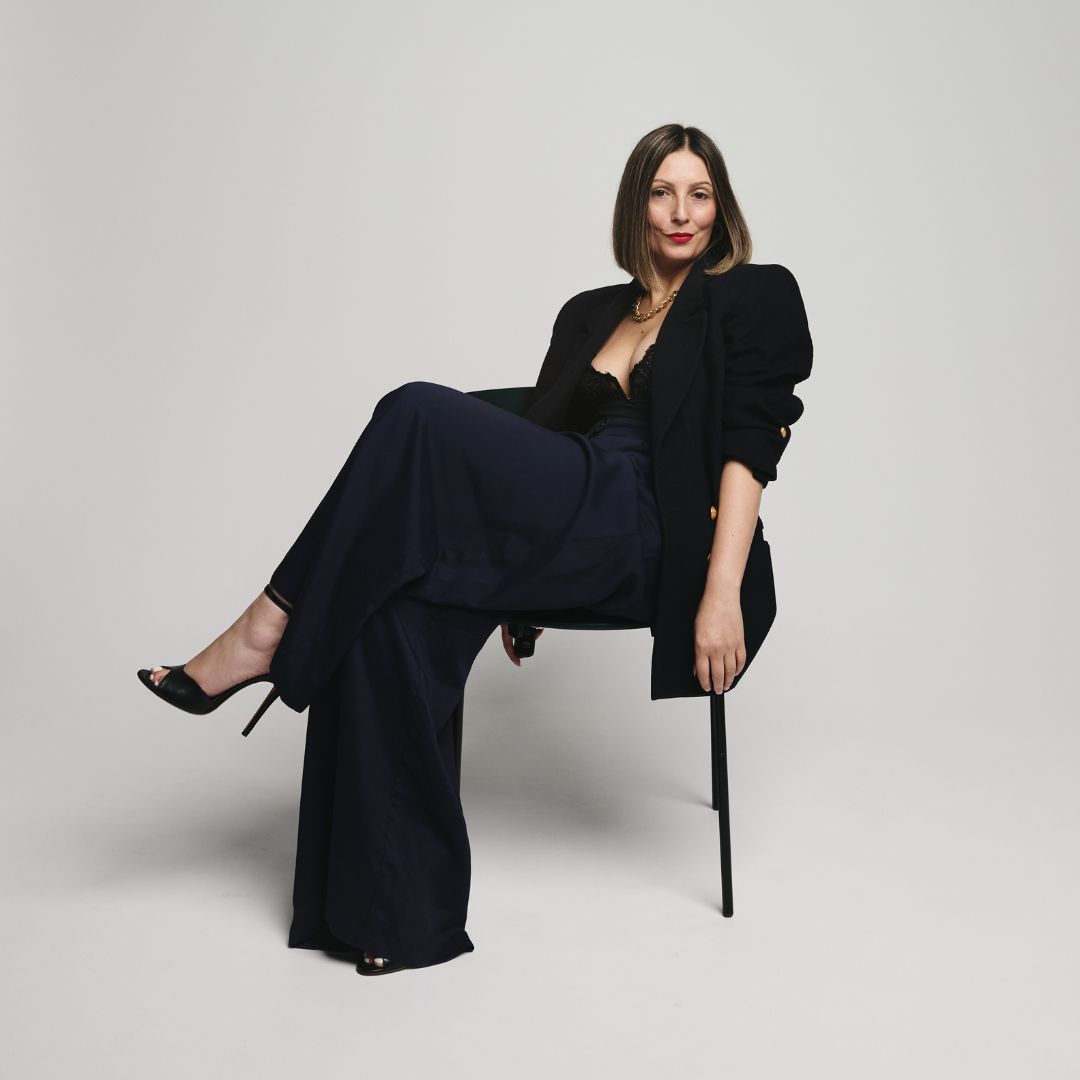 Roberta Lee The Sustainable Stylist London. Elegant Sustainable Powerful Outfit sat in chair.