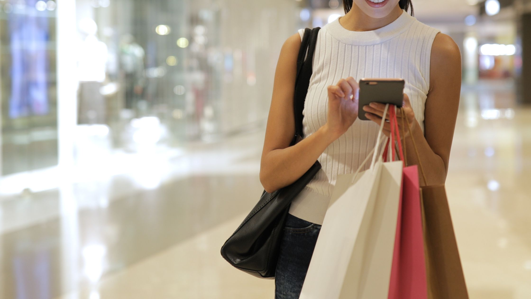 Woman getting SOS style support on her phone whilst shopping