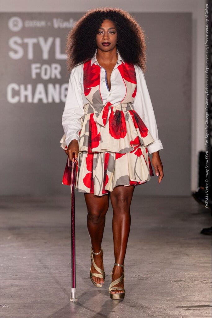 Kadeena Cox floral layered dress
Kadeena Cox in floral layered dress over white shirt with gold platform heels and walking cane – at LFW 