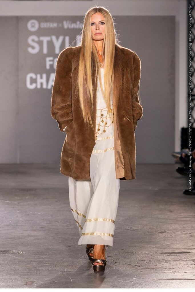Laura Bailey Preloved fur coat look:  wearing 70s inspired white dress with fur coat and platforms at the Oxfam x Vinted Runway Show LFW SS26.”